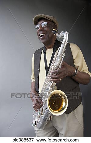 Stock Photo - African American musician holding saxophone. Fotosearch