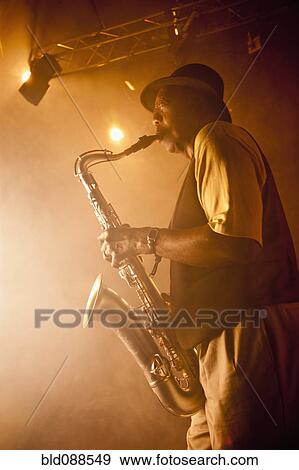 African American musician playing saxophone on stage View Large Photo Image Stock Photo - African American musician playing saxophone on stage. Fotosearch