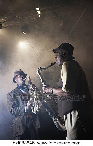 Stock Photograph - African American musicians playing in jazz band on stage. Fotosearch