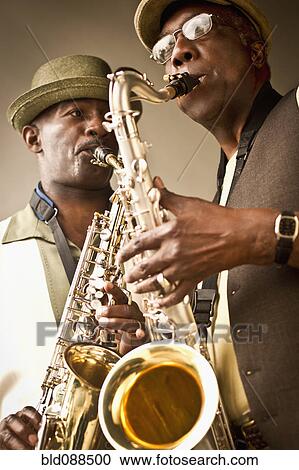 Stock Image - African American musicians playing saxophones together. Fotosearch