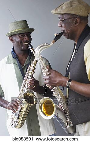 Stock Image - African American musicians playing saxophones together. Fotosearch