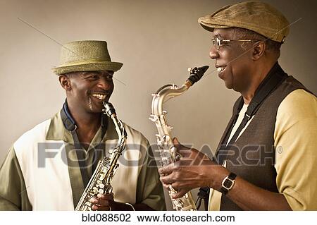 Stock Image - African American musicians playing saxophones together. Fotosearch