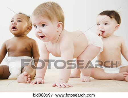 Babies playing together on floor View Large Photo Image Stock Photo - Babies playing together on floor. Fotosearch