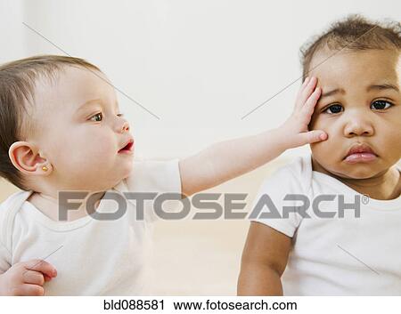 Stock Image - Babies playing together. Fotosearch
