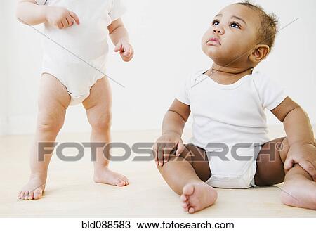 Stock Image - Babies playing together. Fotosearch