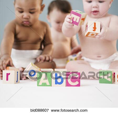 Babies playing with alphabet blocks View Large Photo Image Stock Photo - Babies playing with alphabet blocks. Fotosearch
