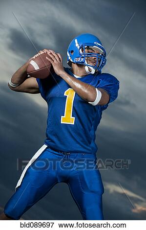Black football player about to throw football View Large Photo Image Stock Photo - Black football player about to throw football. Fotosearch