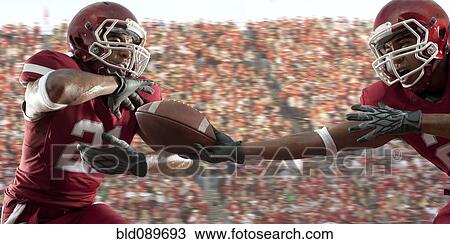 Black football player passing football to teammate View Large Photo Image Stock Image - Black football player passing football to teammate. Fotosearch