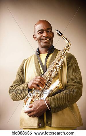 Stock Photography - Black musician holding saxophone. Fotosearch