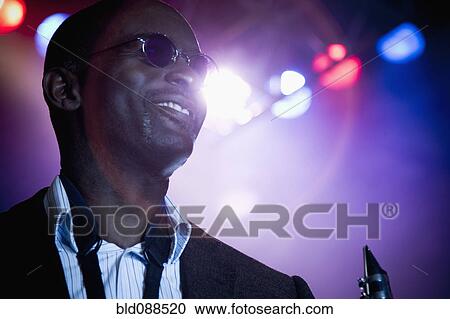 Stock Image - Black musician on stage. Fotosearch