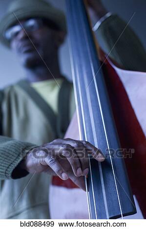 Stock Photo - Black musician playing double bass. Fotosearch