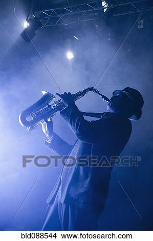 Black musician playing saxophone on stage View Large Photo Image Picture - Black musician playing saxophone on stage. Fotosearch