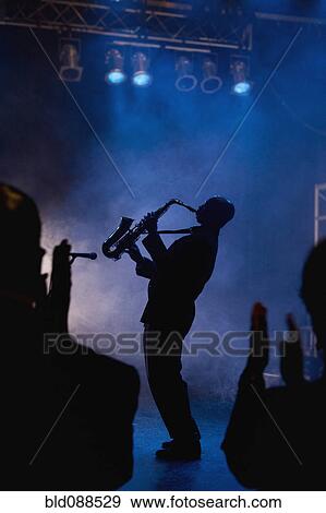 Black musician playing saxophone on stage View Large Photo Image Stock Photo - Black musician playing saxophone on stage. Fotosearch