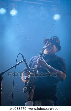 Black musician playing saxophone on stage View Large Photo Image Stock Photo - Black musician playing saxophone on stage. Fotosearch