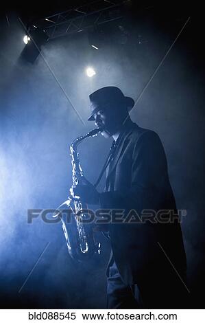 Black musician playing saxophone on stage View Large Photo Image Stock Photography - Black musician playing saxophone on stage. Fotosearch