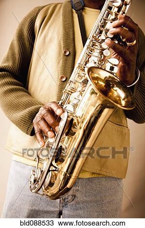 Stock Image - Black musician playing saxophone. Fotosearch