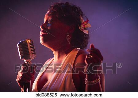 Stock Photography - Black woman singing on stage. Fotosearch