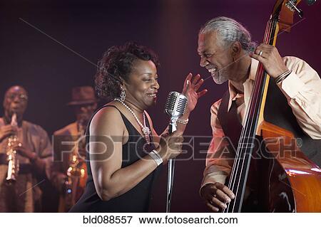 Black woman singing on stage with jazz band View Large Photo Image Stock Photo - Black woman singing on stage with jazz band. Fotosearch