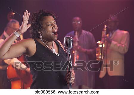 Black woman singing on stage with jazz band View Large Photo Image Stock Photograph - Black woman singing on stage with jazz band. Fotosearch