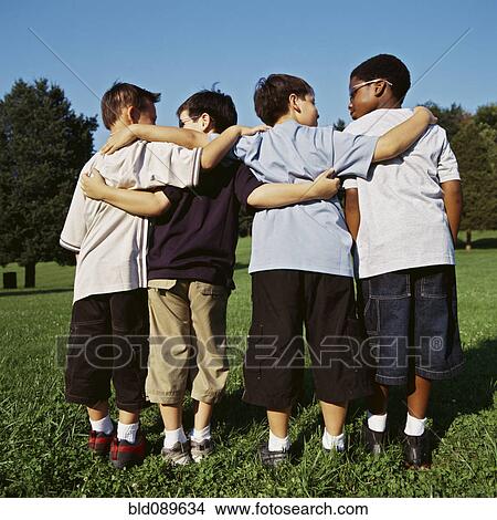 Boys hugging outdoors View Large Photo Image Picture - Boys hugging outdoors. Fotosearch