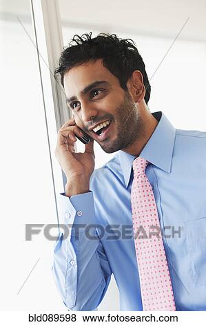 Businessman talking on cell phone View Large Photo Image Stock Photo - Businessman talking on cell phone. Fotosearch