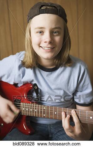 Caucasian boy playing electric guitar View Large Photo Image Stock Photo - Caucasian boy playing electric guitar. Fotosearch