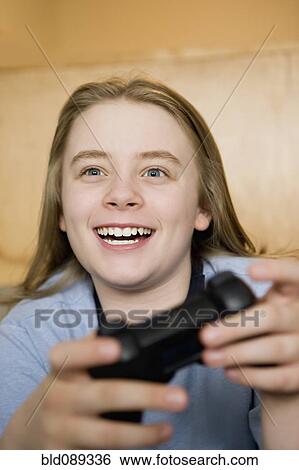 Stock Photograph - Caucasian boy playing video game. Fotosearch