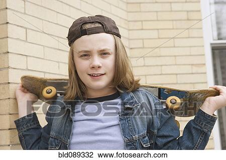 Caucasian boy standing with skateboard View Large Photo Image Stock Image - Caucasian boy standing with skateboard. Fotosearch