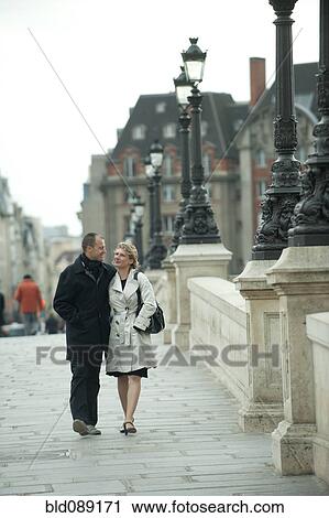 Caucasian couple walking on bridge View Large Photo Image Stock Image - Caucasian couple walking on bridge. Fotosearch