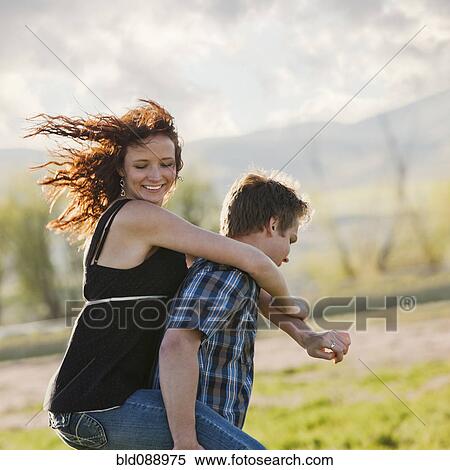 Caucasian man giving girlfriend piggyback ride View Large Photo Image Stock Photography - Caucasian man giving girlfriend piggyback ride. Fotosearch