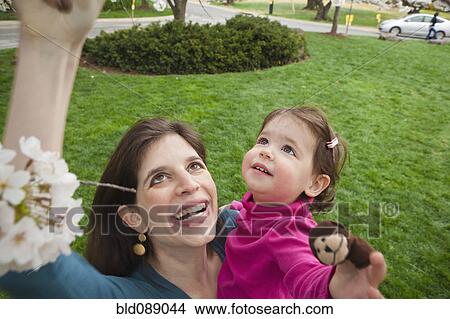 Caucasian mother and daughter smiling outdoors View Large Photo Image Picture - Caucasian mother and daughter smiling outdoors. Fotosearch