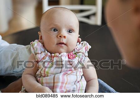 Caucasian parents admiring baby daughter View Large Photo Image Stock Photography - Caucasian parents admiring baby daughter. Fotosearch