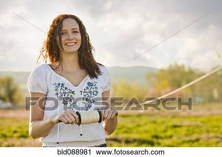 Stock Image - Caucasian woman flying kite. Fotosearch