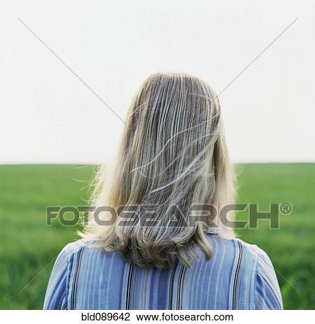 Caucasian woman standing in green field View Large Photo Image Stock Image - Caucasian woman standing in green field. Fotosearch
