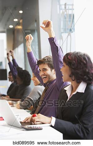 Stock Photography - Cheering Hispanic business people in office. Fotosearch
