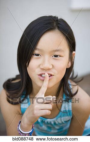 Chinese girl making shhh gesture View Large Photo Image Stock Photo - Chinese girl making shhh gesture. Fotosearch