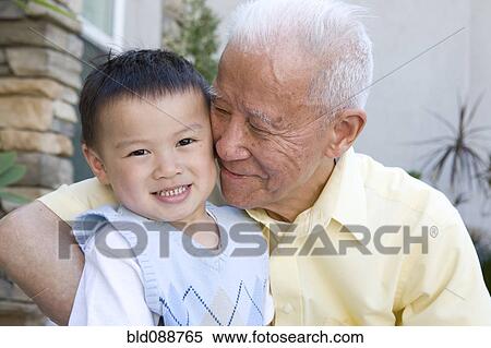 Stock Photography - Chinese grandfather hugging grandson. Fotosearch