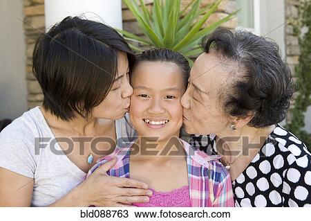 Chinese grandmother and mother kissing daughter View Large Photo Image Stock Image - Chinese grandmother and mother kissing daughter. Fotosearch