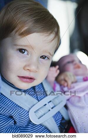 Stock Photo - Close up of young boy in car seat. Fotosearch