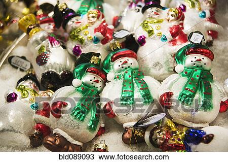 Stock Image - Delicate snowmen Christmas ornaments. Fotosearch