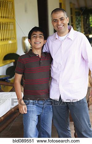 Stock Image - Father and son hugging. Fotosearch