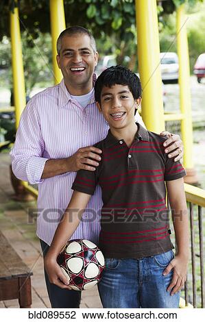 Stock Image - Father and son hugging. Fotosearch
