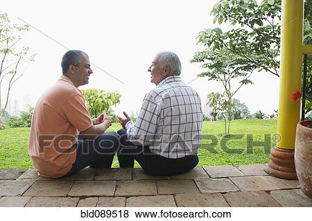 Father and son talking outdoors View Large Photo Image Stock Photo - Father and son talking outdoors. Fotosearch