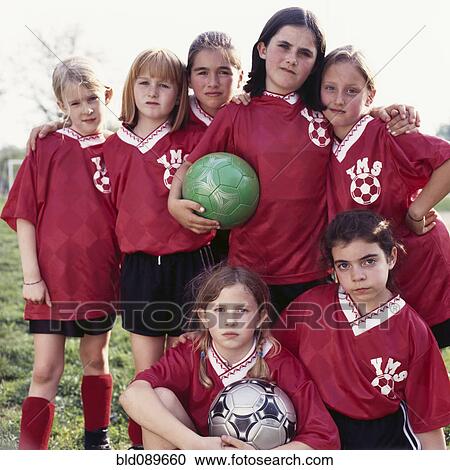 Stock Image - Girl soccer team in uniform standing together. Fotosearch