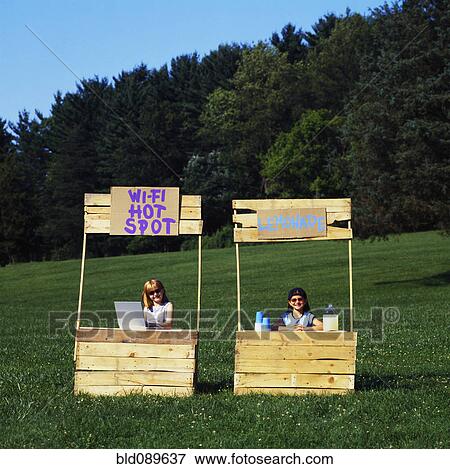 Girls with wi-fi enabled lemonade stand one without View Large Photo Image Stock Photo - Girls with wi-fi enabled lemonade stand one without. Fotosearch