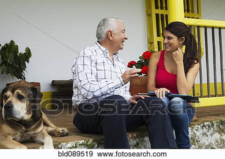 Grandfather and granddaughter talking outdoors View Large Photo Image Stock Photo - Grandfather and granddaughter talking outdoors. Fotosearch