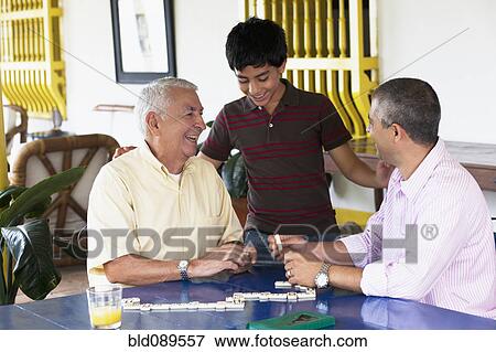 Grandfather and grandson playing dominoes View Large Photo Image Stock Photo - Grandfather and grandson playing dominoes. Fotosearch