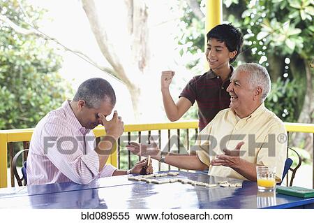 Grandfather, father and son playing dominoes on porch View Large Photo Image Stock Photography - Grandfather, father and son playing dominoes on porch. Fotosearch