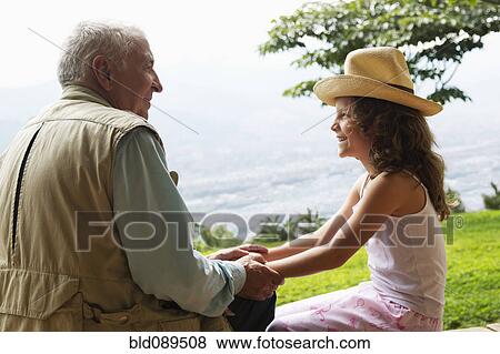 Grandfather holding hands with granddaughter View Large Photo Image Stock Photo - Grandfather holding hands with granddaughter. Fotosearch