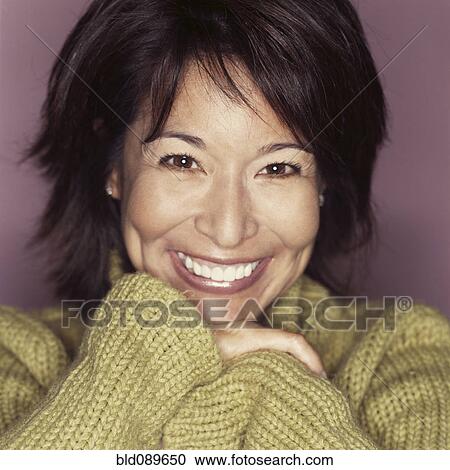 Stock Image - Grinning mixed race woman. Fotosearch